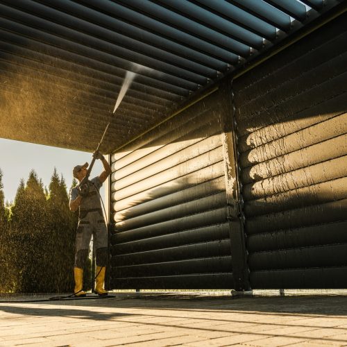 Men with Pressure Washer Cleaning His Residential Aluminium Carport Pergola